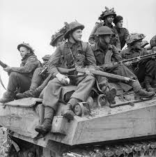 British soldiers riding on a tank